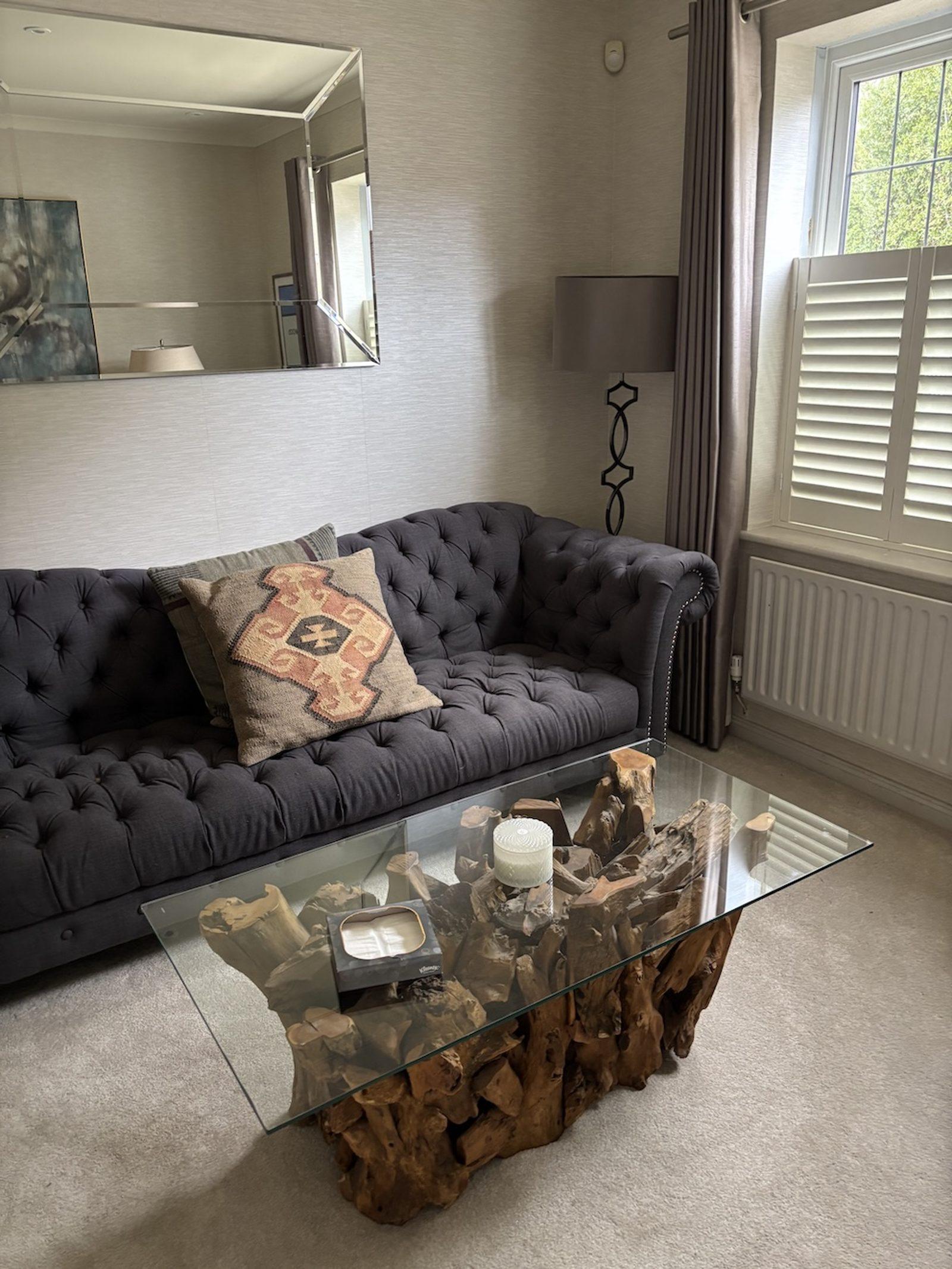 A calm, softly lit consulting room with a warm sofa and natural furnishings, where sessions take place